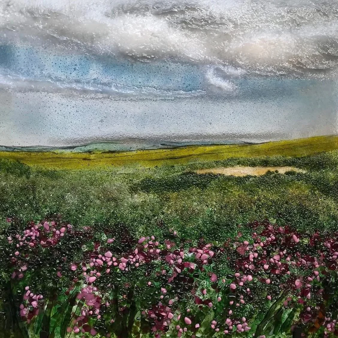 Abstract textured landscape painting with blue-gray sky, green hills, and pink wildflowers