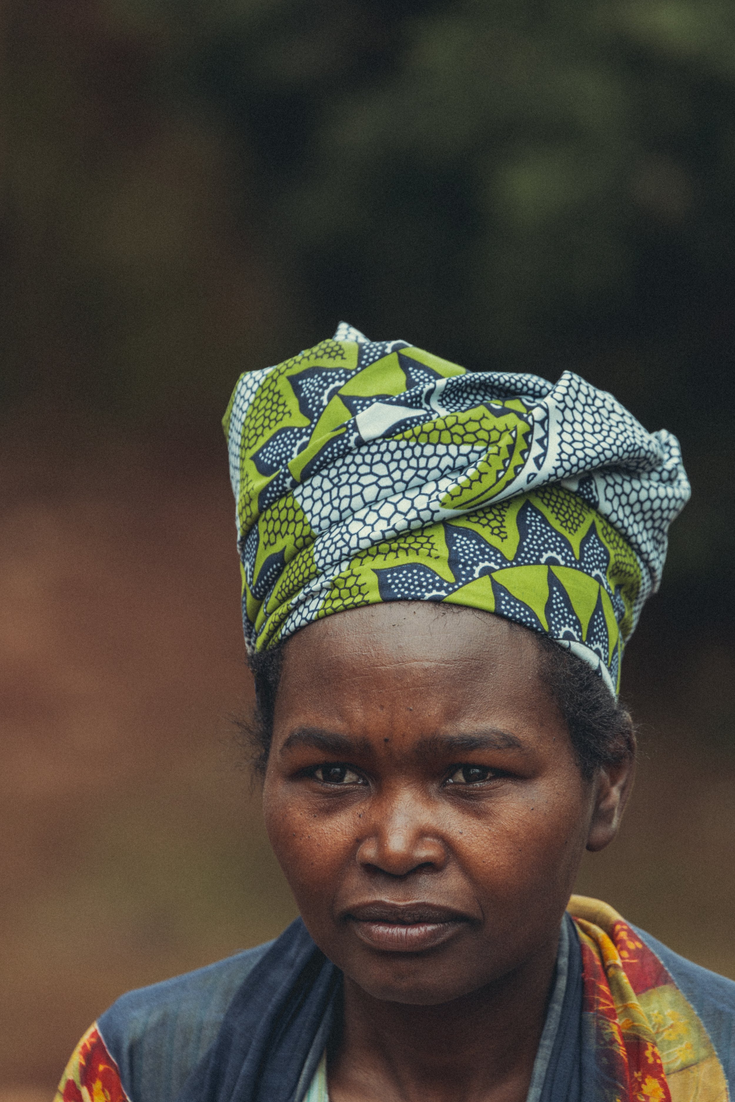 Close-up portrait of a Rwandan woman wearing a colorful patterned headwrap and clothing.Photo by David Ferry Jr.