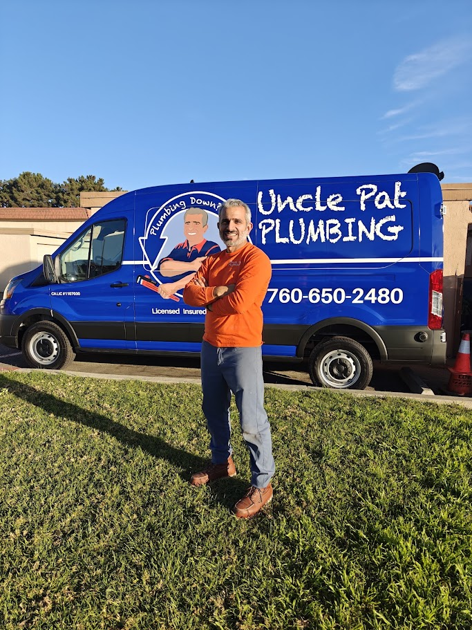 Pat standing in front of the Uncle Pat Plumbing van.