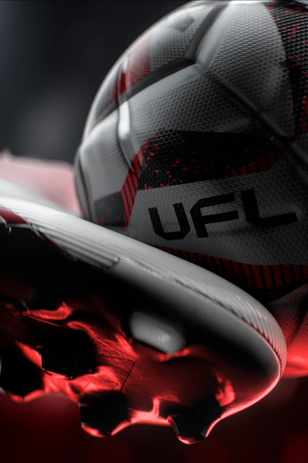 Close-up of a black, white, and red soccer cleat with textured upper and studs