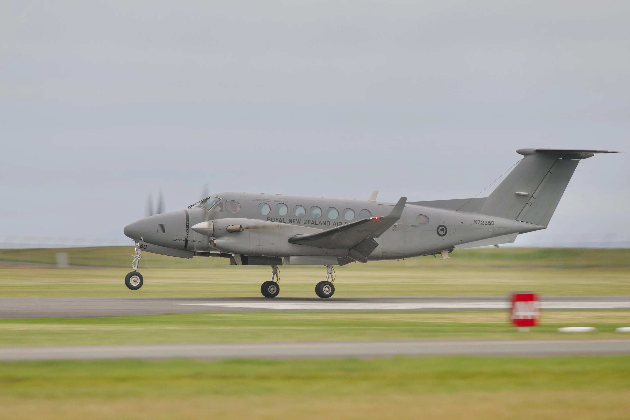 Royal New Zealand Air Force twin-engine turboprop aircraft landing on a runway