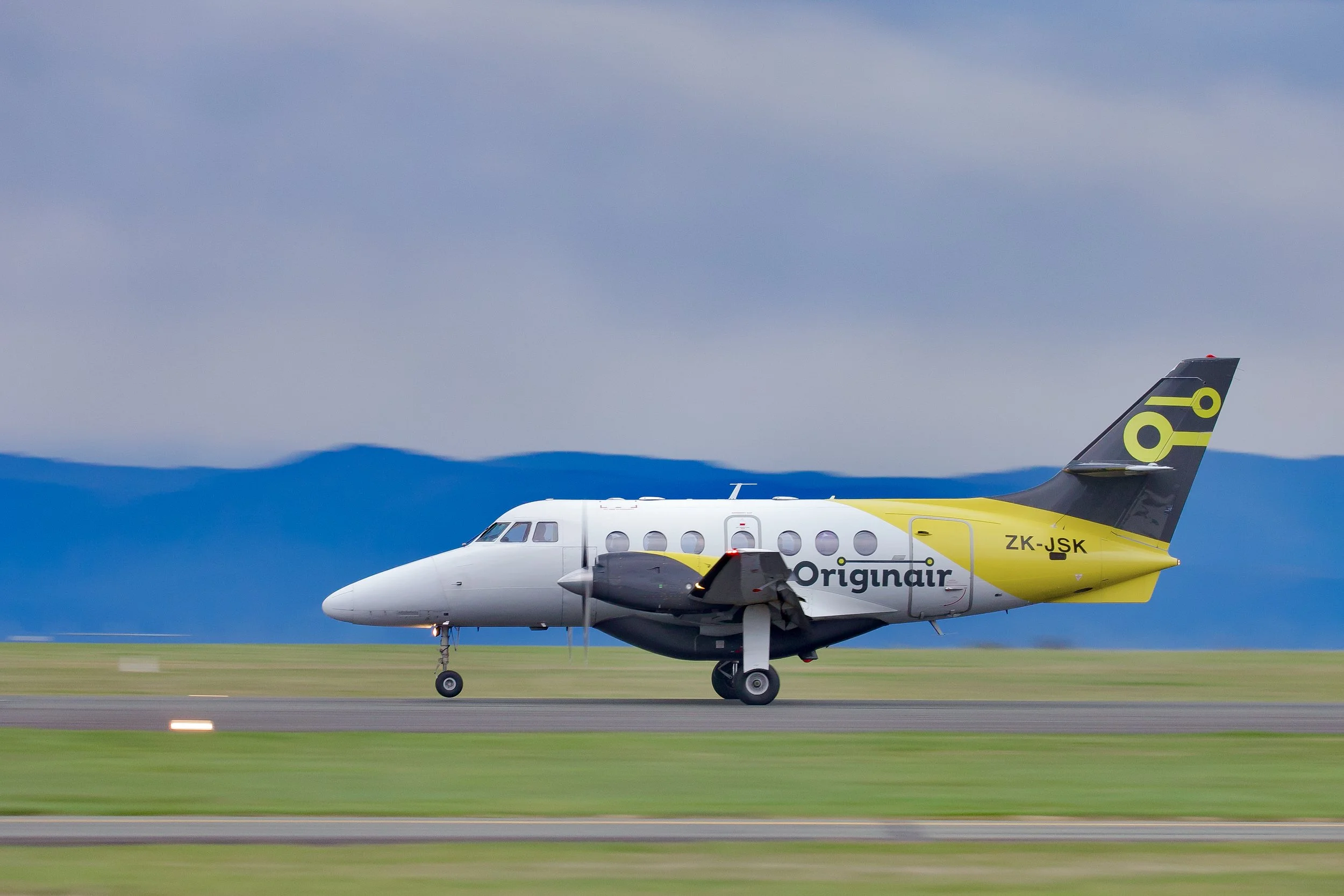 Originair twin-engine passenger aircraft taxiing on a runway