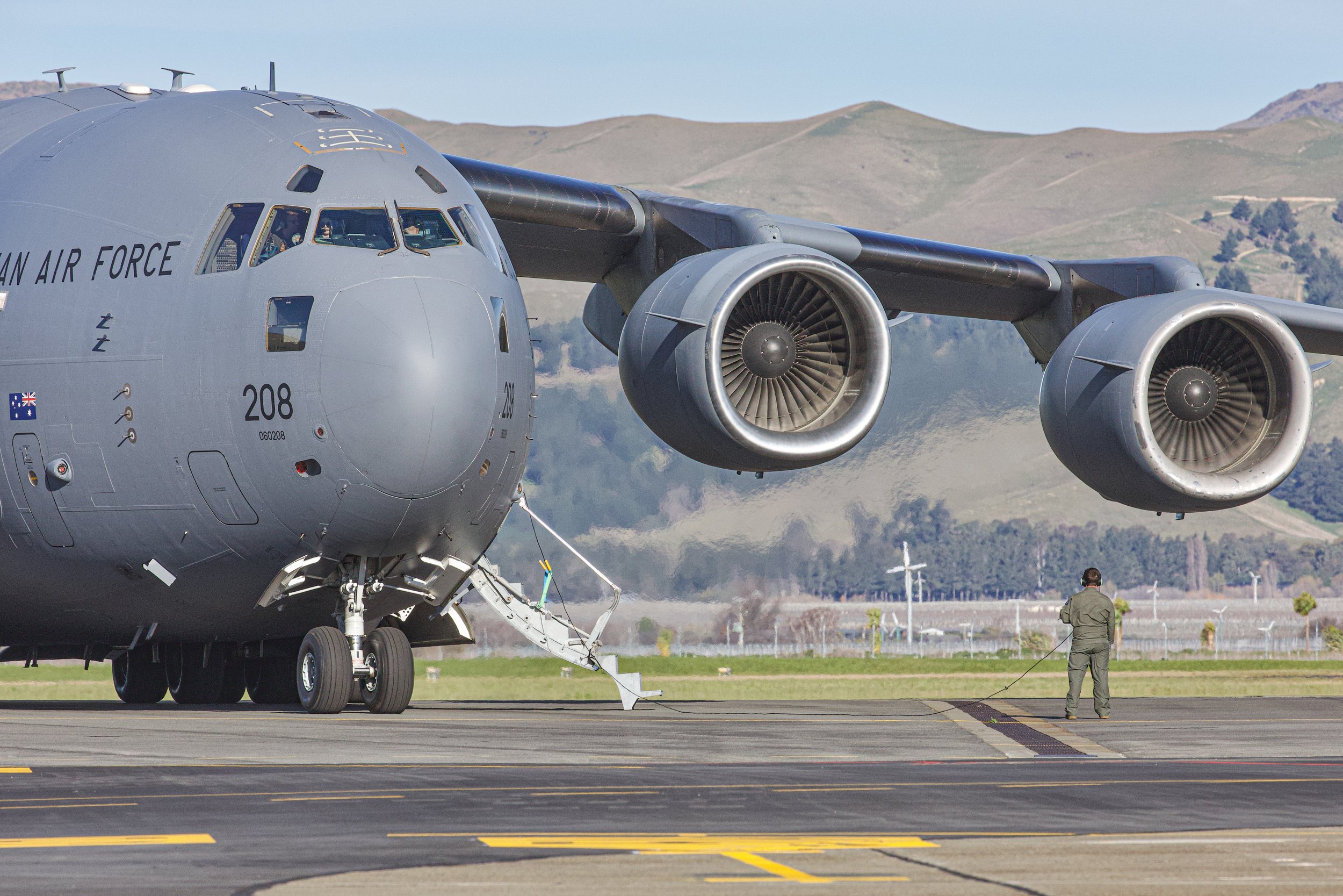 U.S. Air Force C-17 Globemaster III military transport aircraft on a runway with mountains in the background