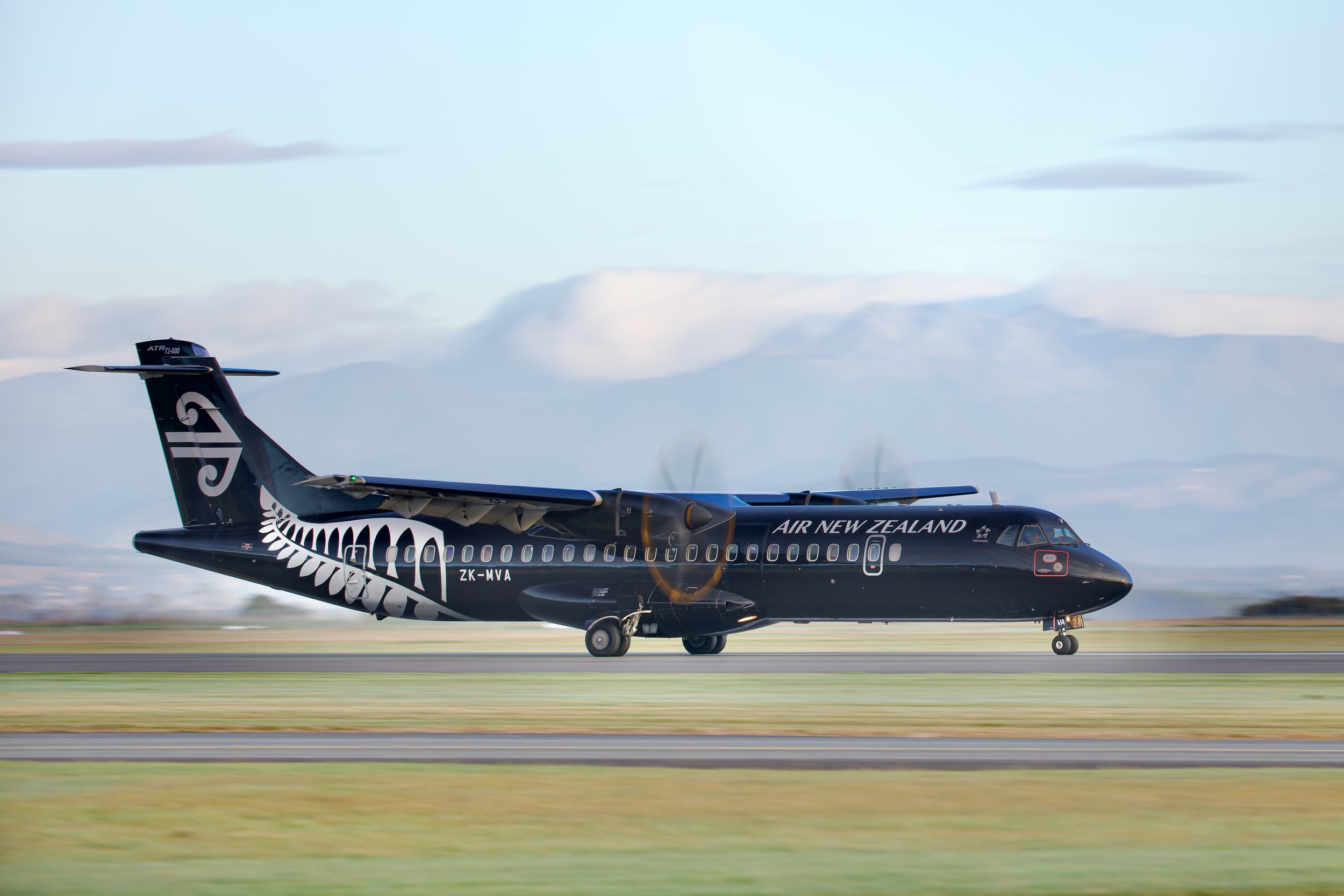 Air New Zealand ATR 72 turboprop passenger plane in black livery taxiing on a runway