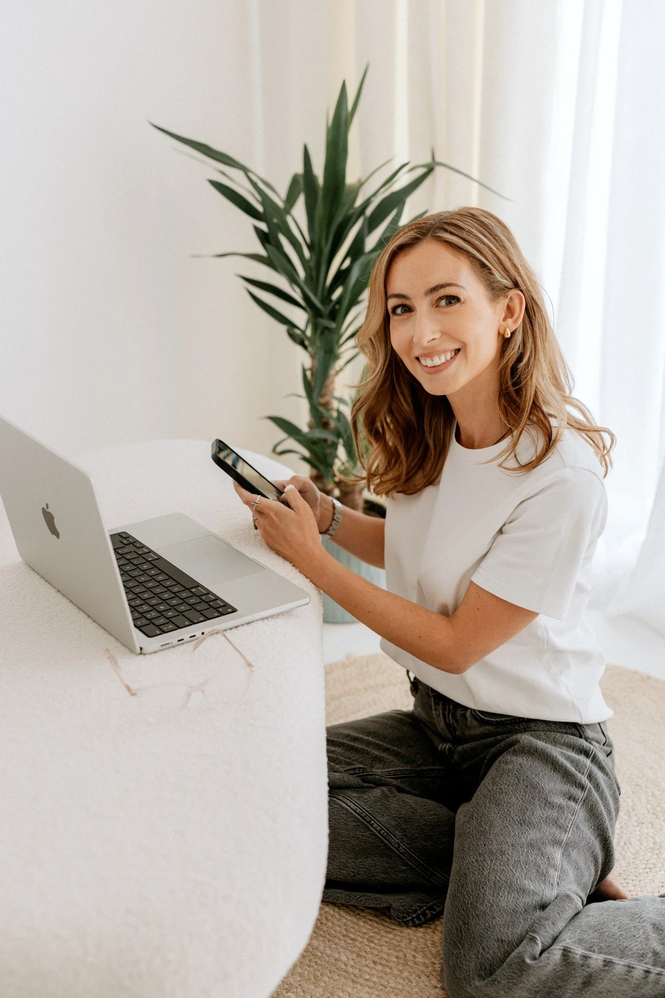 Emily, founder of Ad Clarity, smiling with her laptop