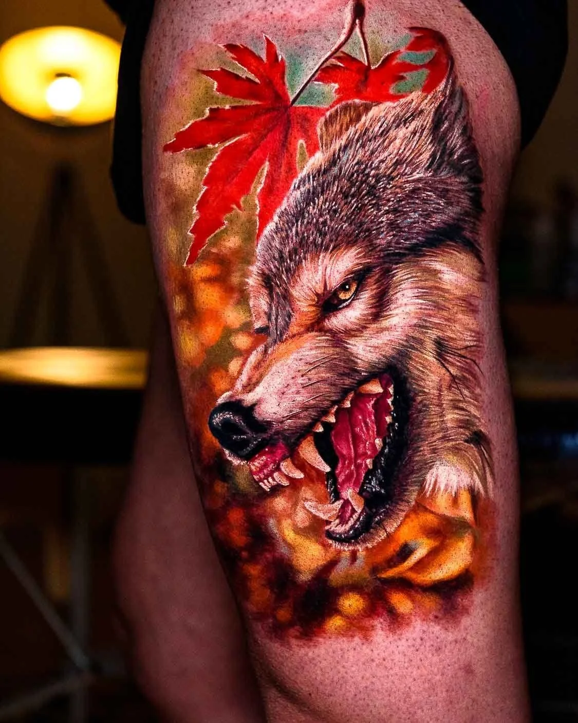 Color realism wolf tattoo with detailed fur and red autumn maple leaves.