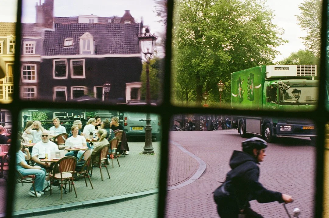 Four-panel street scene in the Netherlands showing historic canal houses, a tree-lined road with a green truck, an outdoor café, and a cyclist.