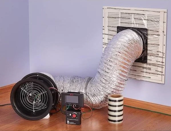 Portable ventilation fan with flexible duct connected to a wall vent, electronic controller, and striped cup indoors