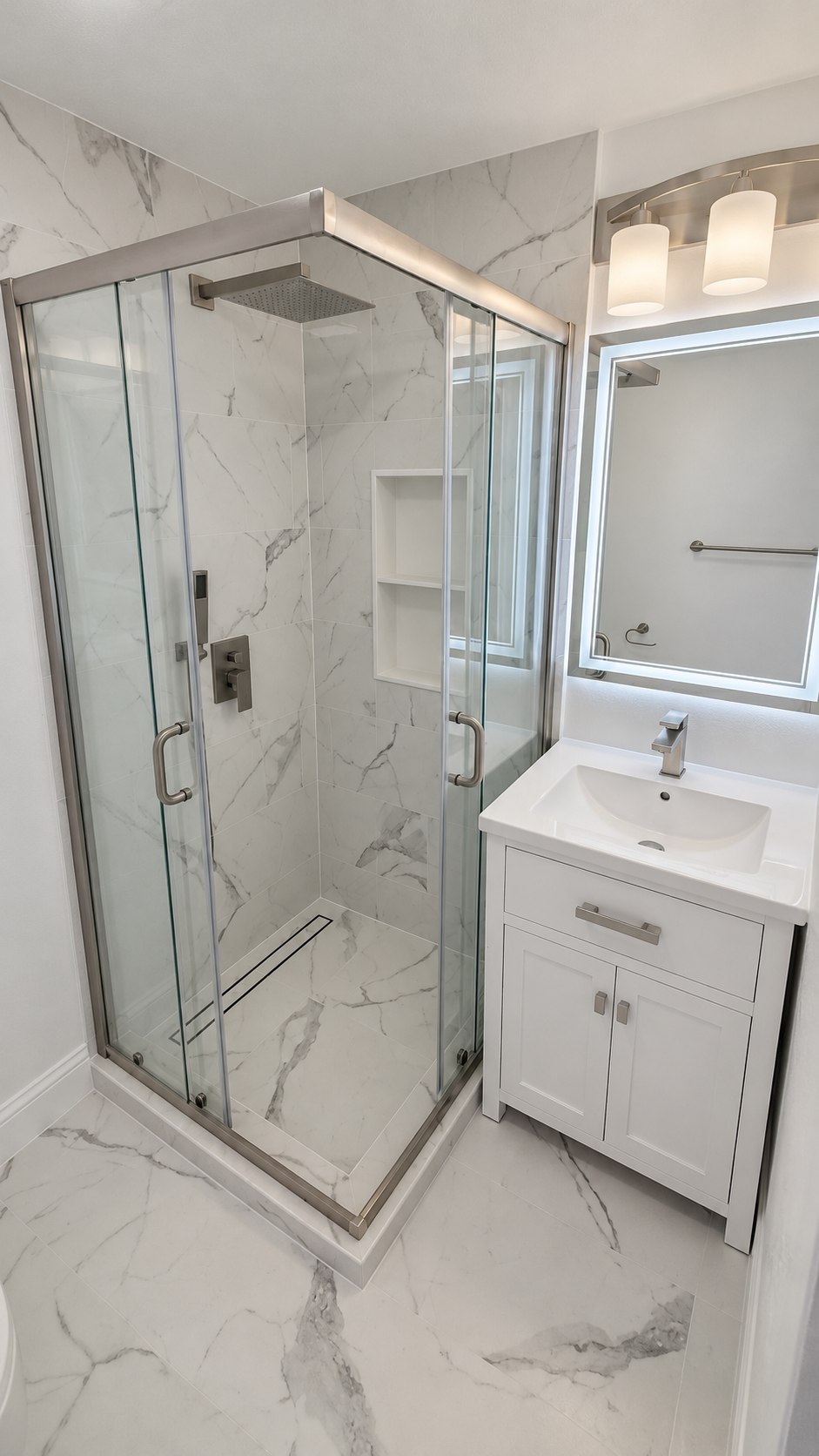 Bathroom with marble-look tile, glass shower enclosure and white vanity
