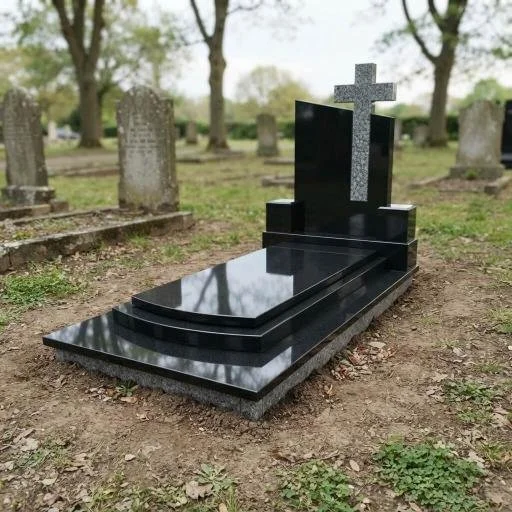 Polished black granite grave monument with a cross in a cemetery