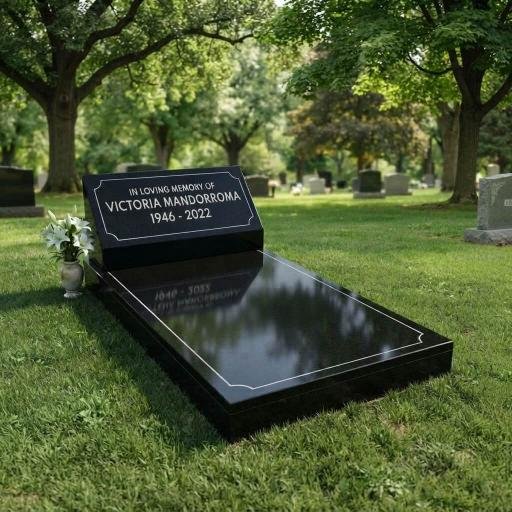 Black granite memorial grave marker for Victoria Mandorroma, 1946–2022, in a tree-lined cemetery.
