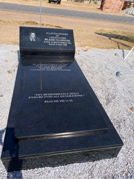 Black granite memorial grave marker for Blasio Mahonde, engraved with a remembrance message and Psalm 102:12