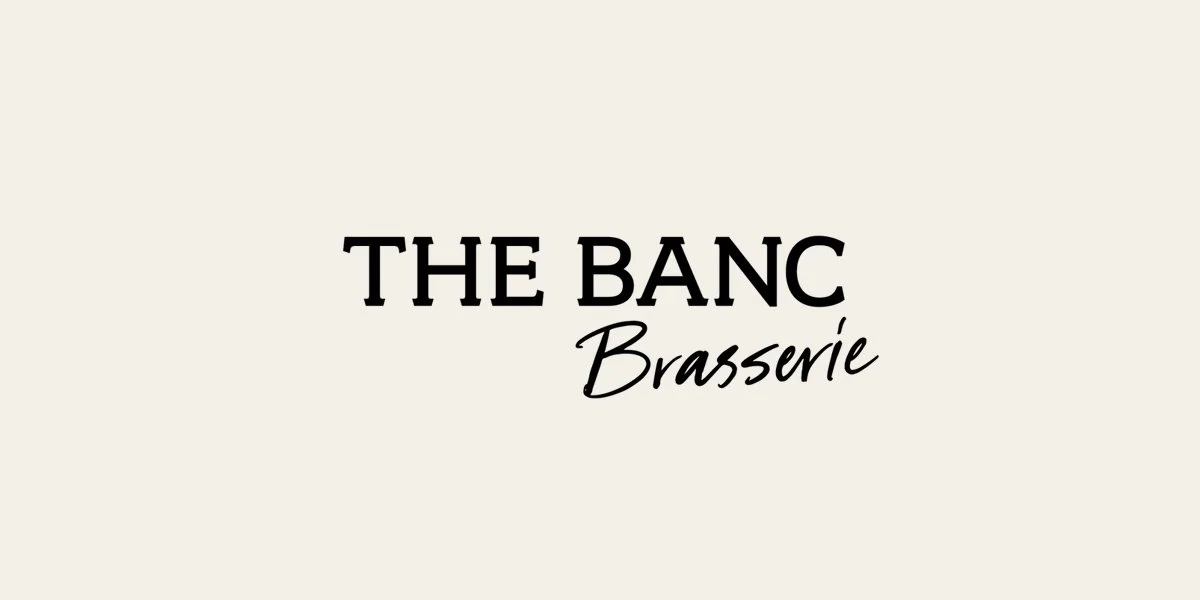 The Banc Brasserie logo in black lettering on a cream background