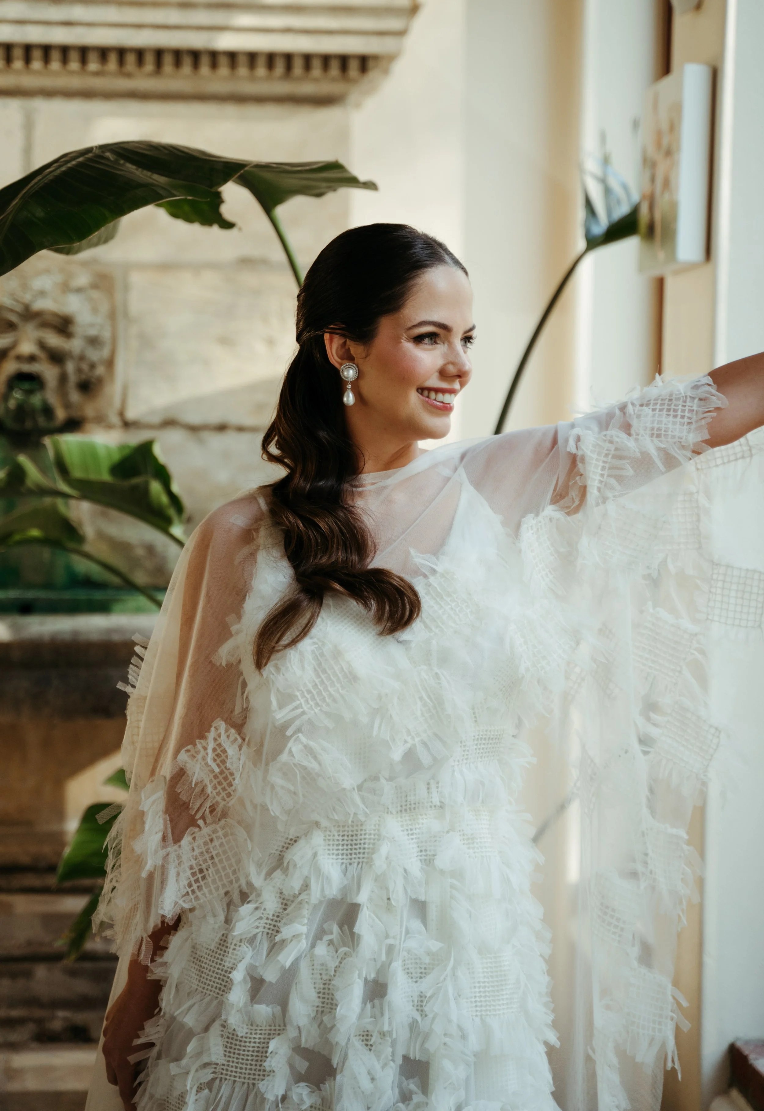 Bride standing by window