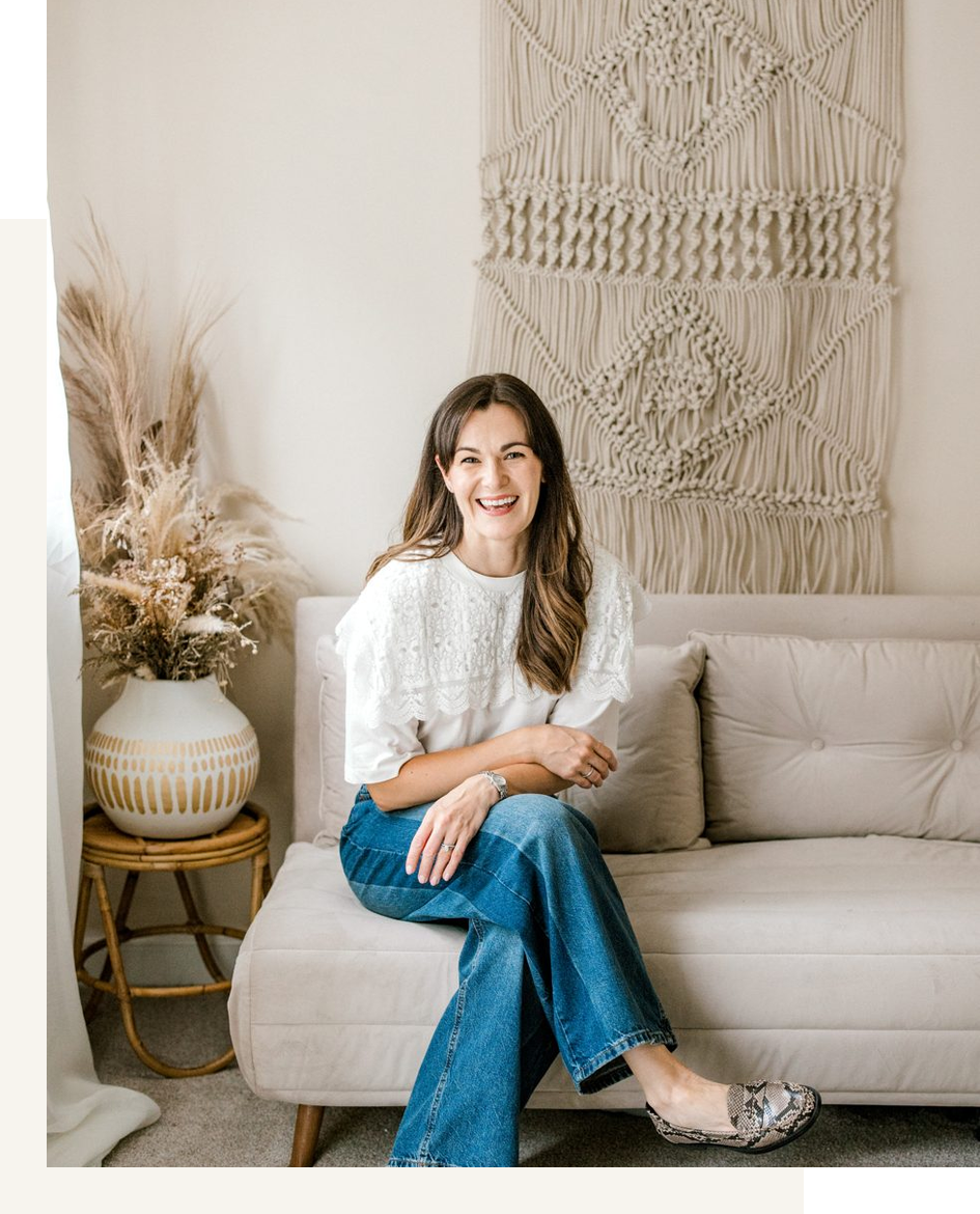 Gill Alexander, brand consultant and founder of GA Consulting, sitting on a sofa smiling