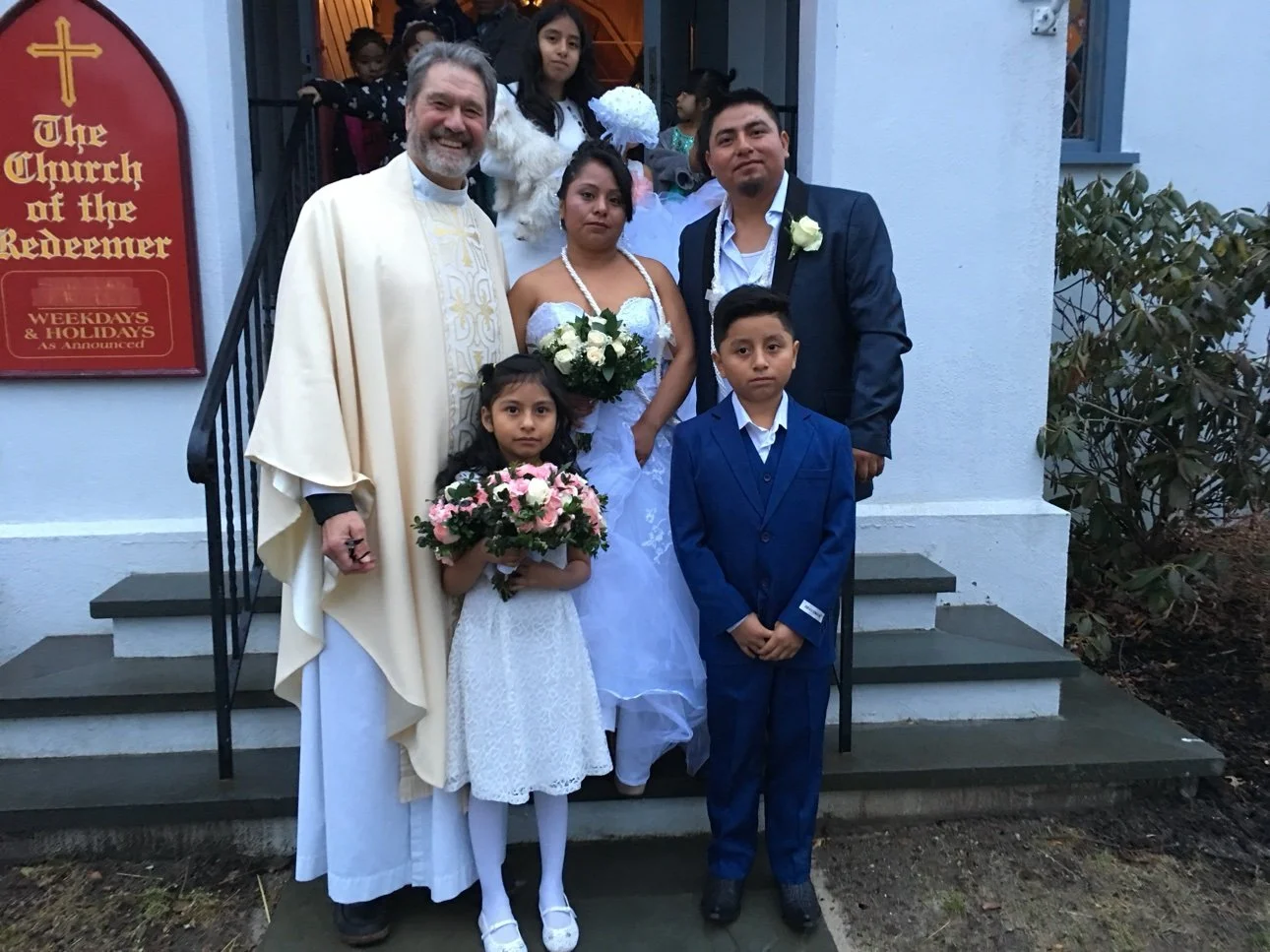 Wedding group on the church steps with Fr. Joslin