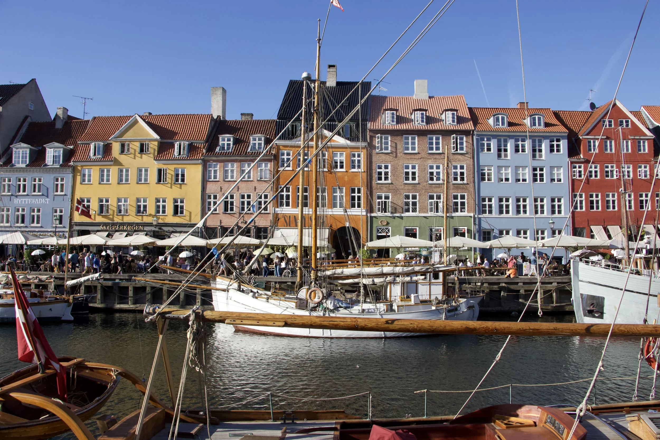 Colorful historic waterfront buildings and sailing boats in Nyhavn harbor, Copenhagen, Denmark
