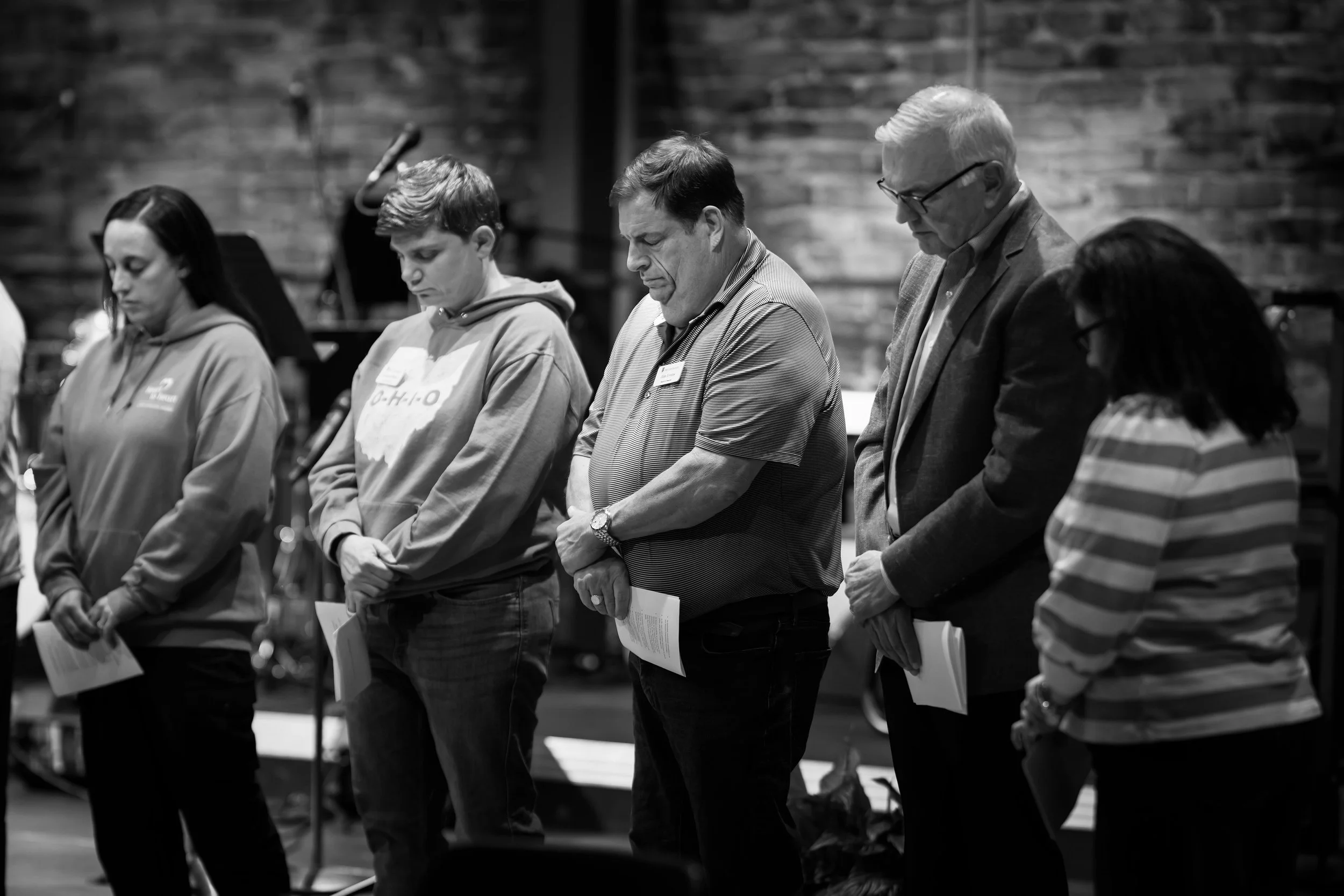 SEARCH - Members of the committee pray over their commitment to serve.