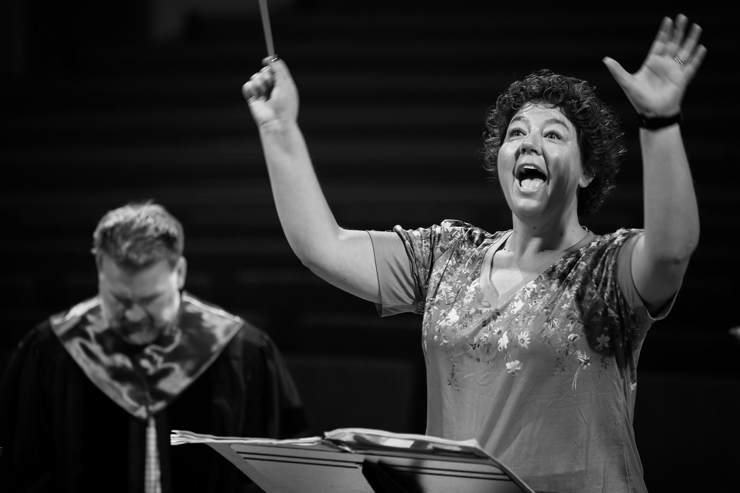 SOLI - Associate Director Amy Johnston Blosser prepares the choir for 'Soli Deo Gloria' as her husband, Director of Music Andy Blosser, listens in.