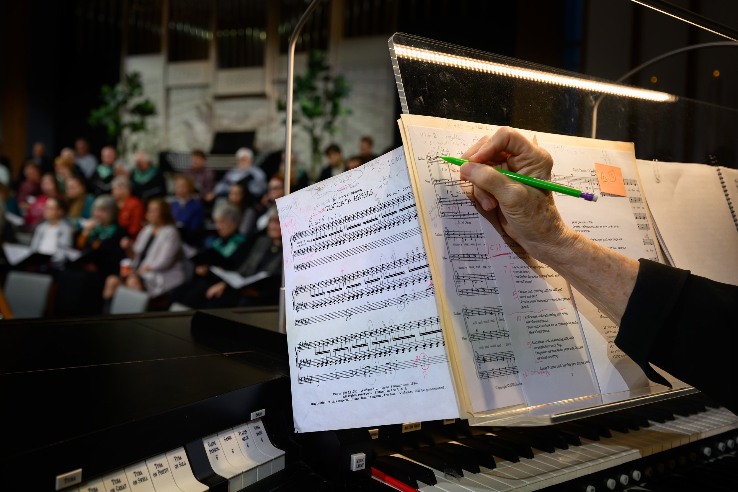 SOLI - Organist May Schwarz marks up music during rehearsal for 'Soli Deo Gloria'.
