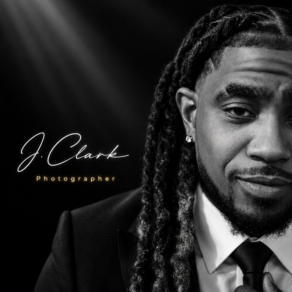 Black-and-white portrait of photographer J. Clark in a suit and tie with long dreadlocks, with his name and title displayed.