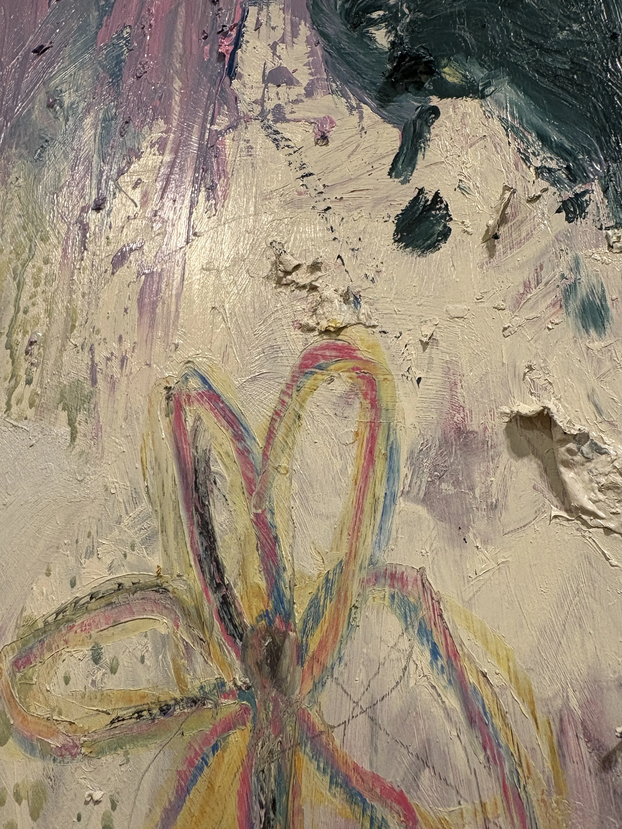 Close-up of a heavily textured abstract painting with layered beige, purple, teal, red, yellow, and blue brushstrokes.
