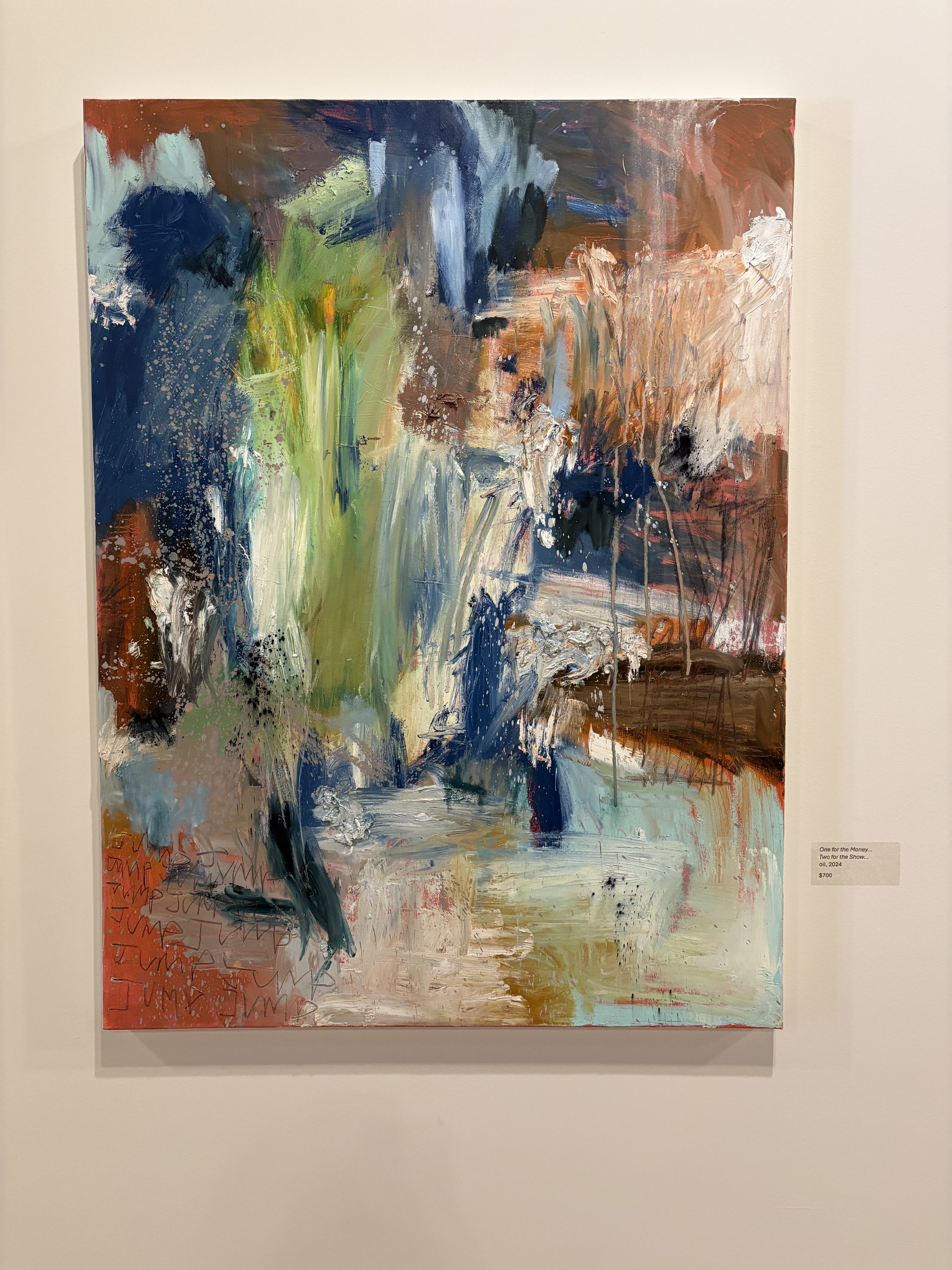 Large colorful abstract painting displayed in a gallery, featuring layered blue, green, orange, white, and brown brushstrokes.