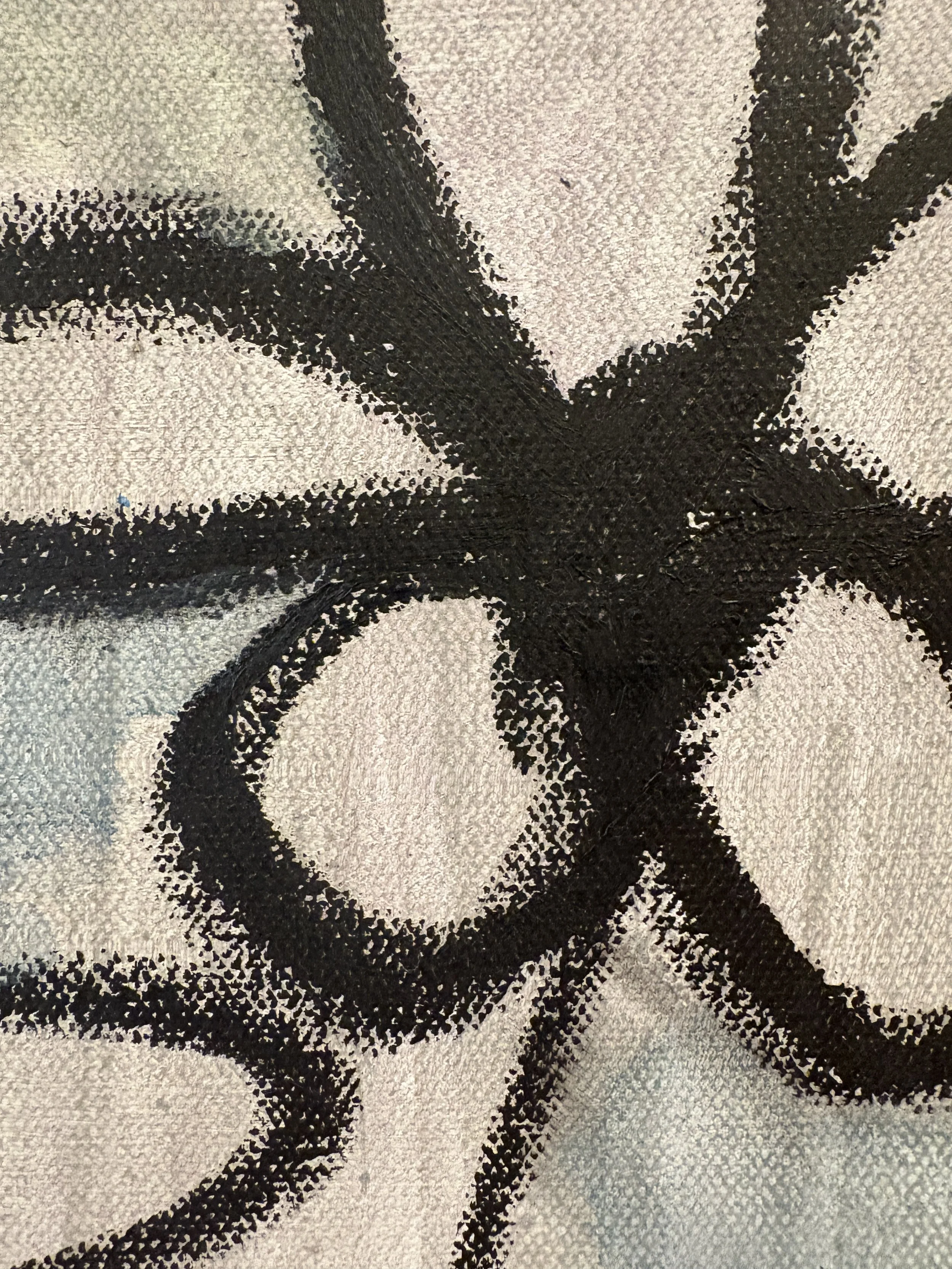 Close-up of a black, gray, and cream abstract geometric fabric pattern
