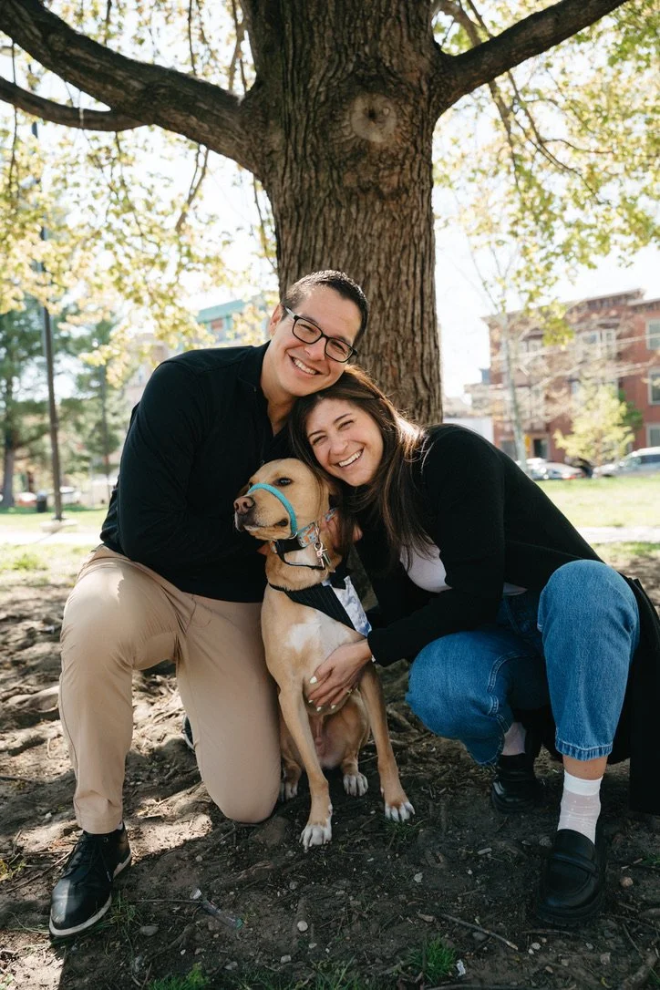 Noodle sitting with his family beneath a tree.