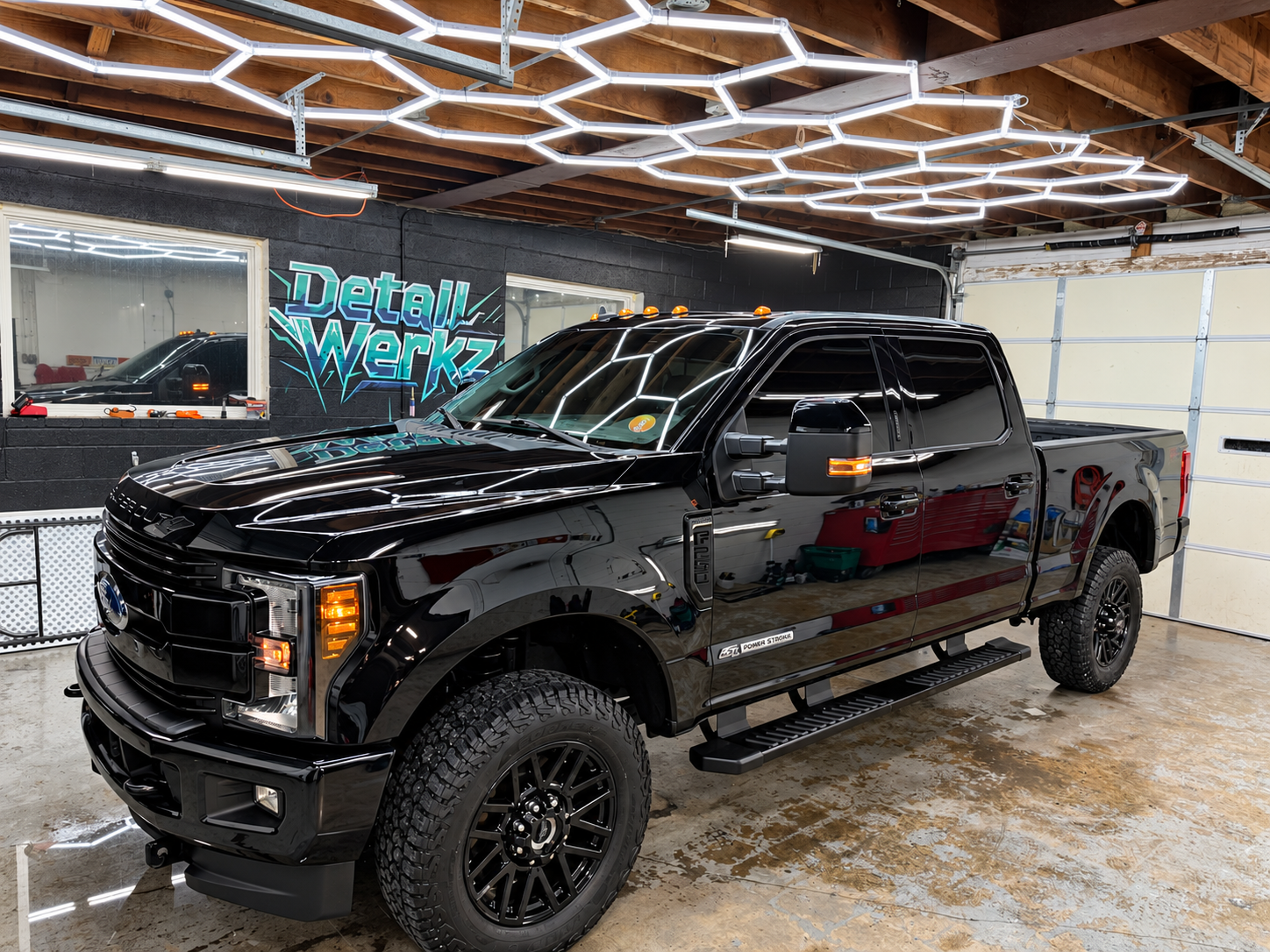 Black Ford Super Duty customer truck in the Detail Werkz shop