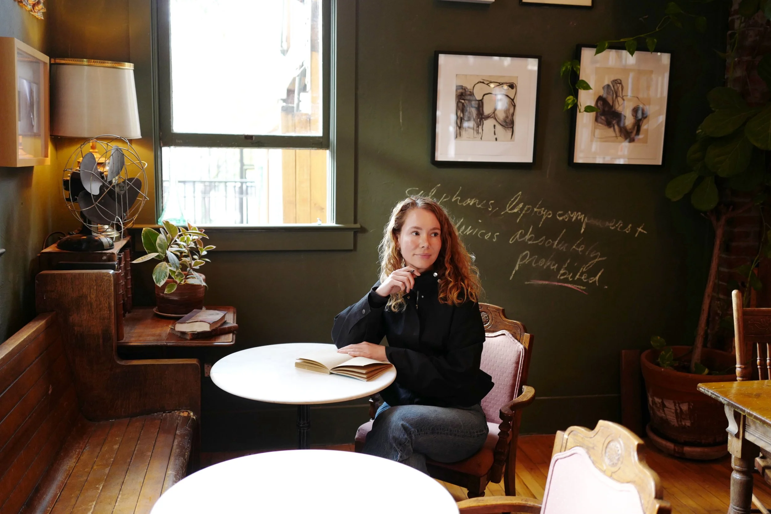 Sonya Trachsel writing at a cafe.