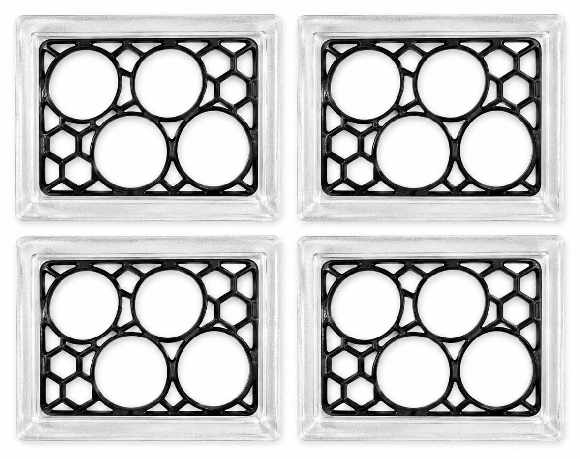 Four rectangular coin display cases with black geometric patterns and circular openings