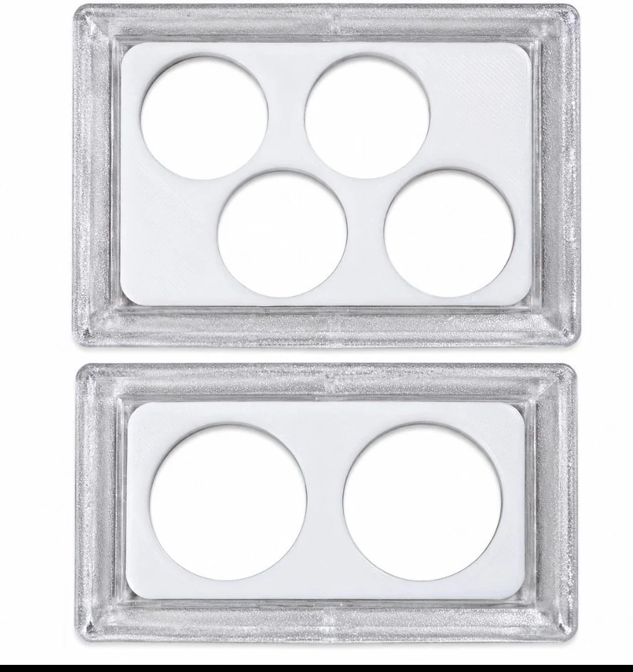 Two clear coin cases with white inserts, featuring four circular openings on the top plate and two on the bottom