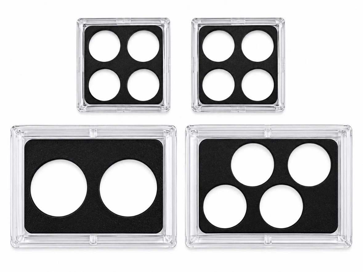 Four clear plastic display cases with black inserts and circular cutouts in assorted sizes