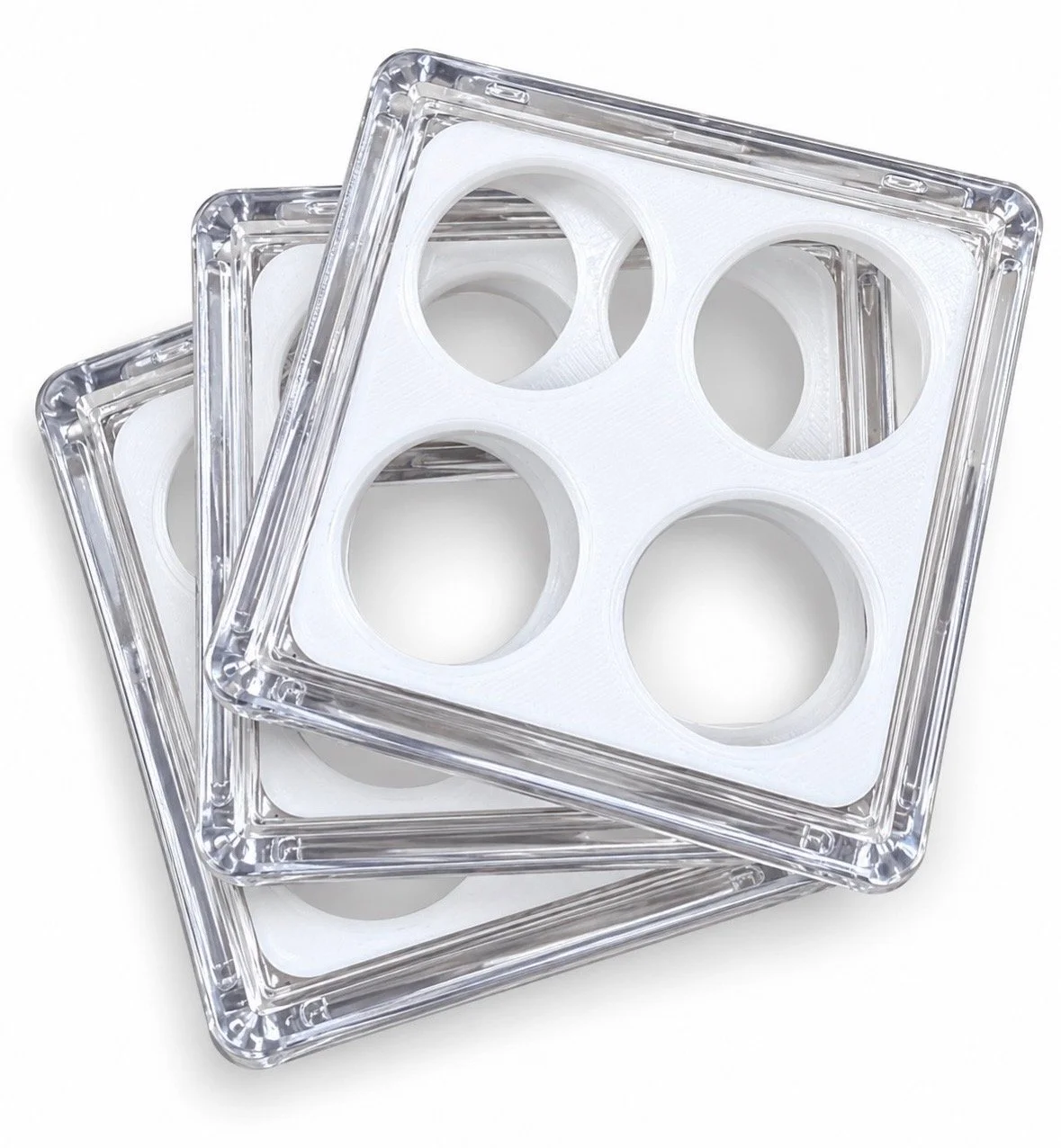 Stack of clear square coin cases with white four-hole inserts