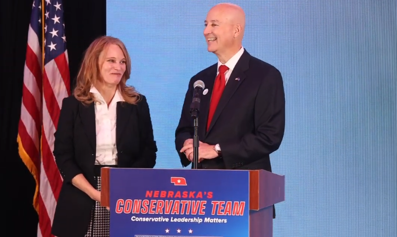 Susanne Shore and Sen. Pete Ricketts at a podium reading Nebraska's Conservative Team, Conservative Leadership Matters