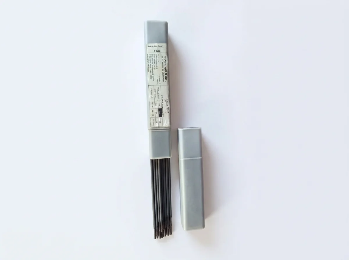 Open gray box of 4xG welding electrodes beside its matching gray lid on a white background
