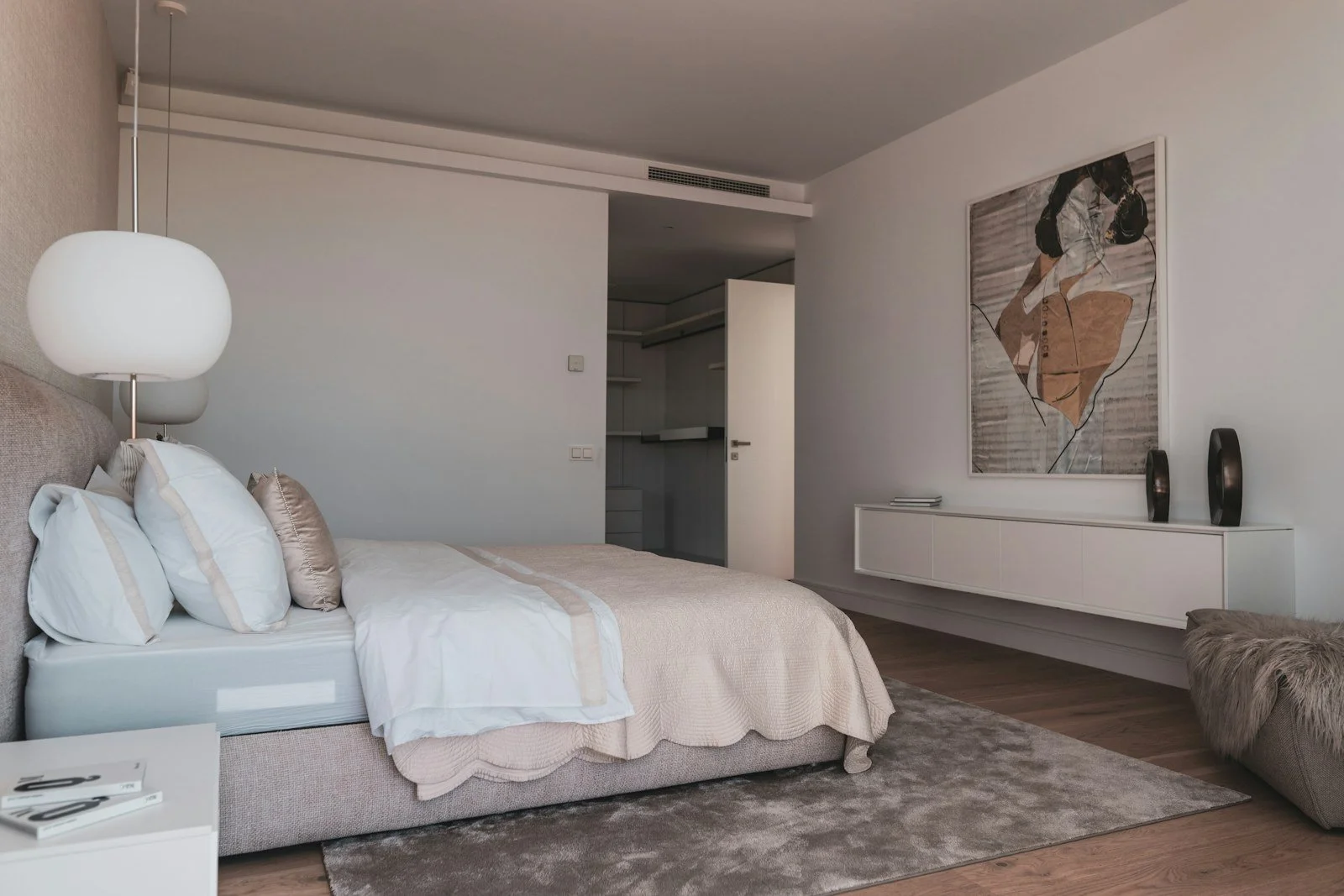 Bright bedroom with the bed freshly made