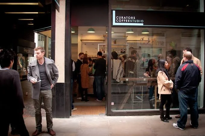Crowd outside Curators Coffee Studio café in an urban shopping arcade