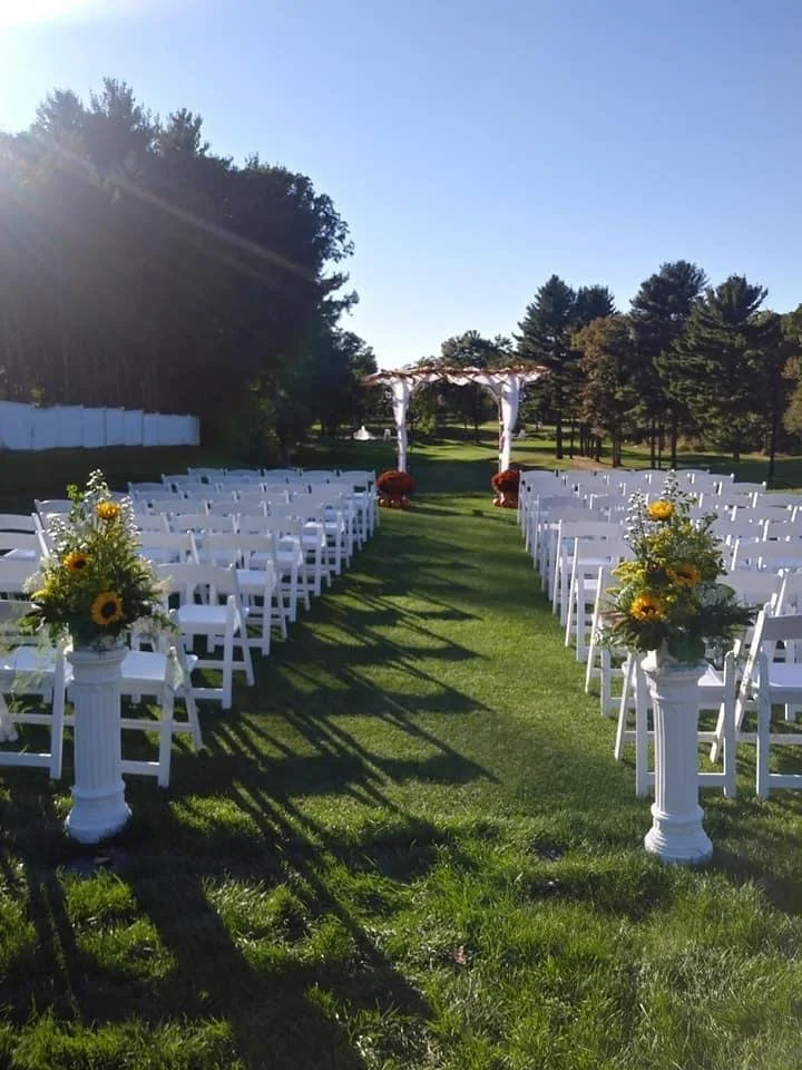 Outdoor ceremony aisle decorated with sunflowers