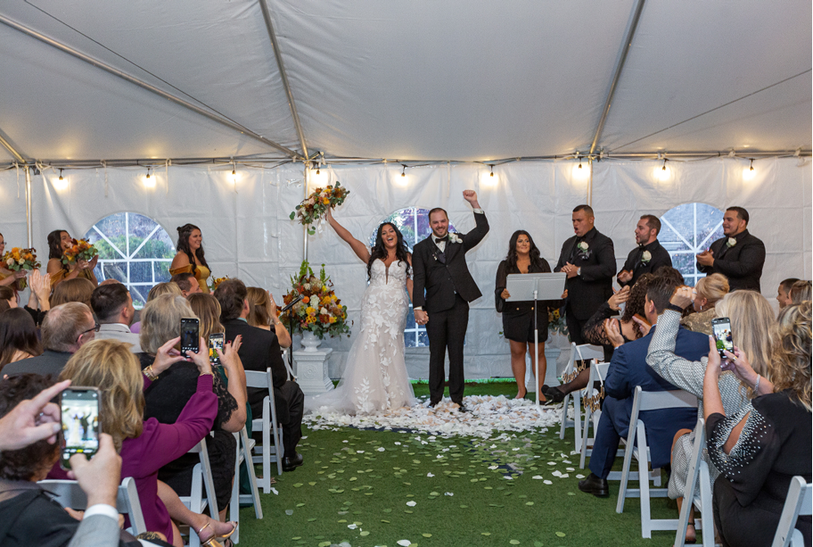 Newlyweds celebrating their ceremony in the tent
