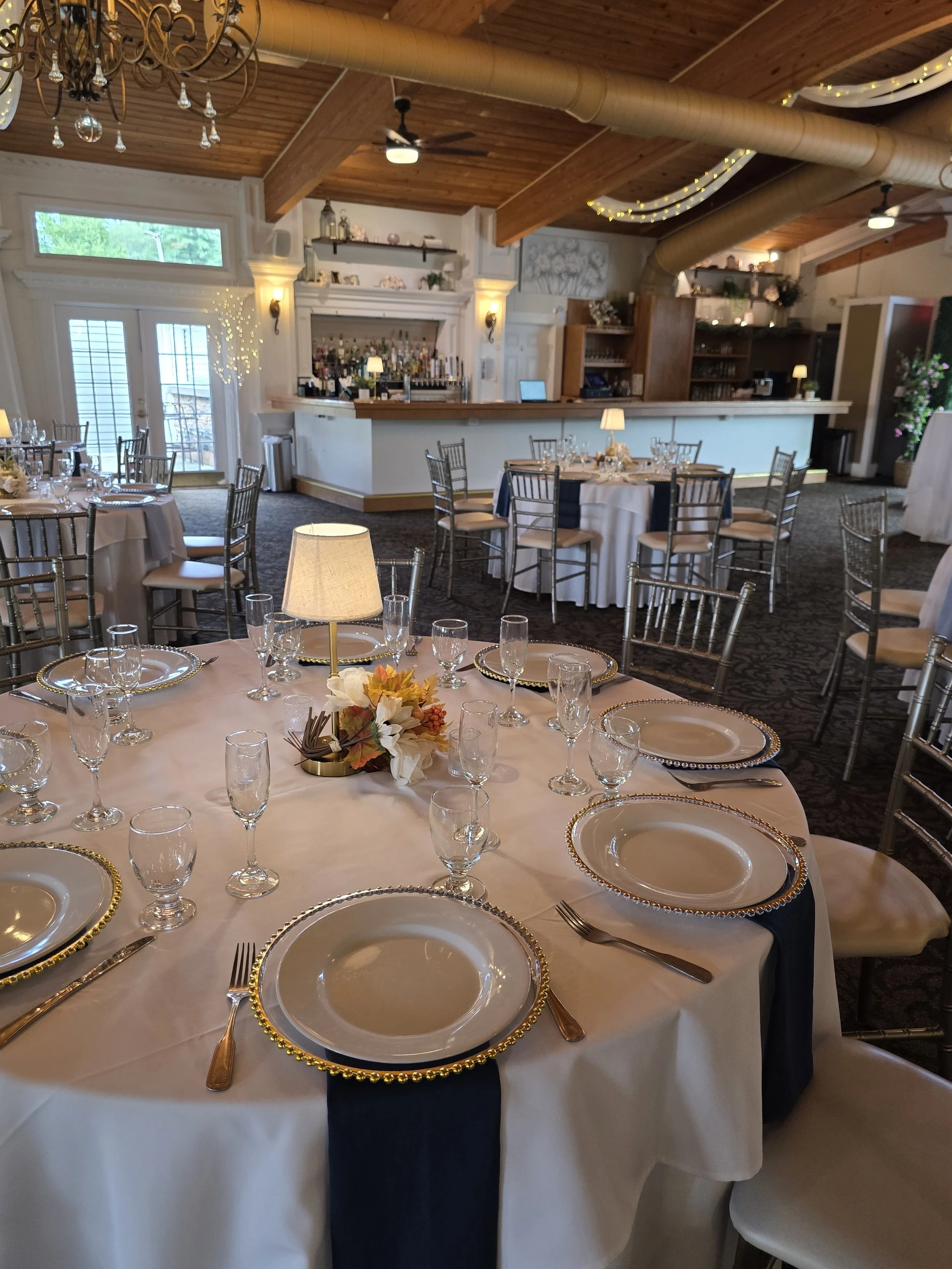 BellaVista tables with navy napkins and bar view