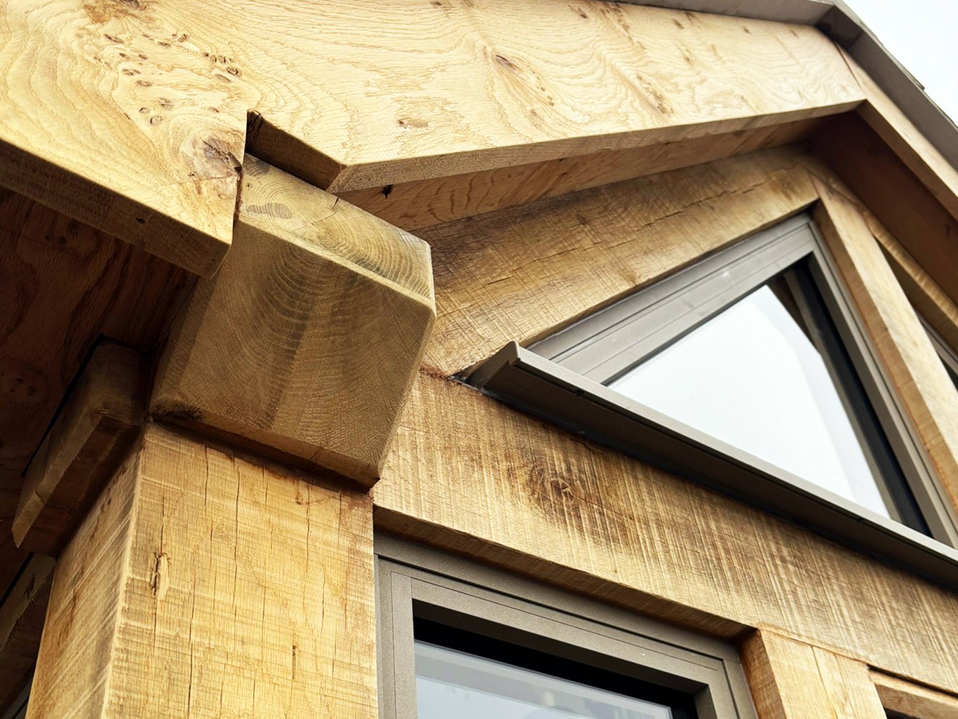 Close-up of oak framed structure with modern aluminium windows