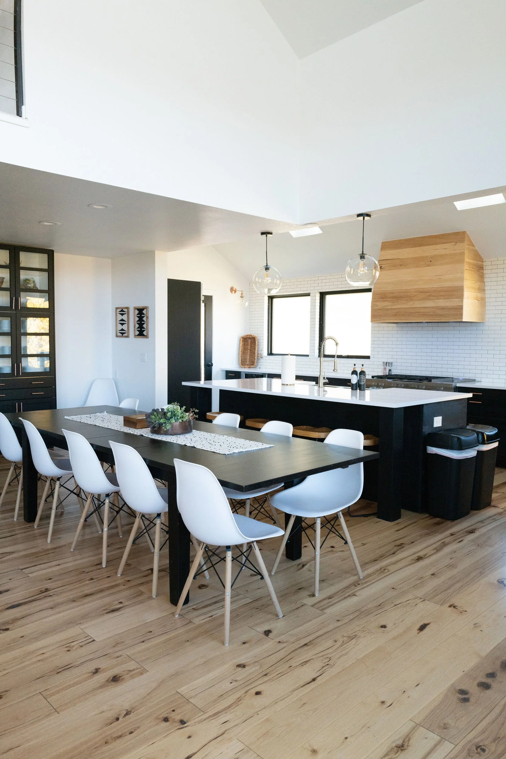 Modern dining room with white chairs, a long wood table and wood floors in Hot Sulphur Springs, Colorado