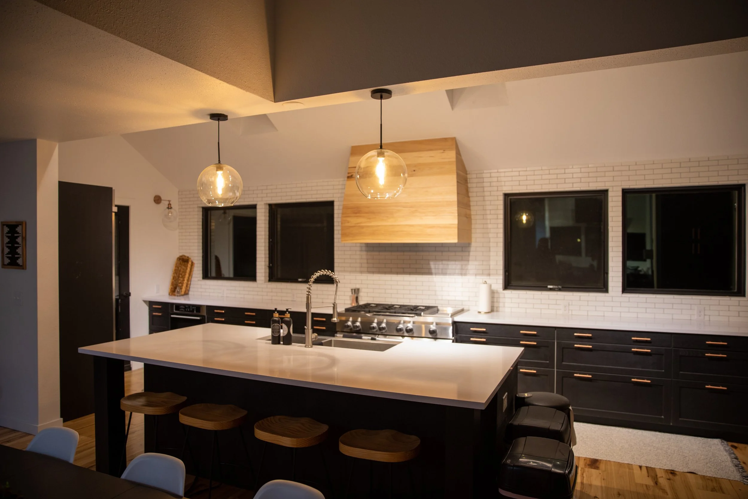 Modern kitchen with a white island and pendant lights at Tundra Springs, Colorado mountain wedding venue