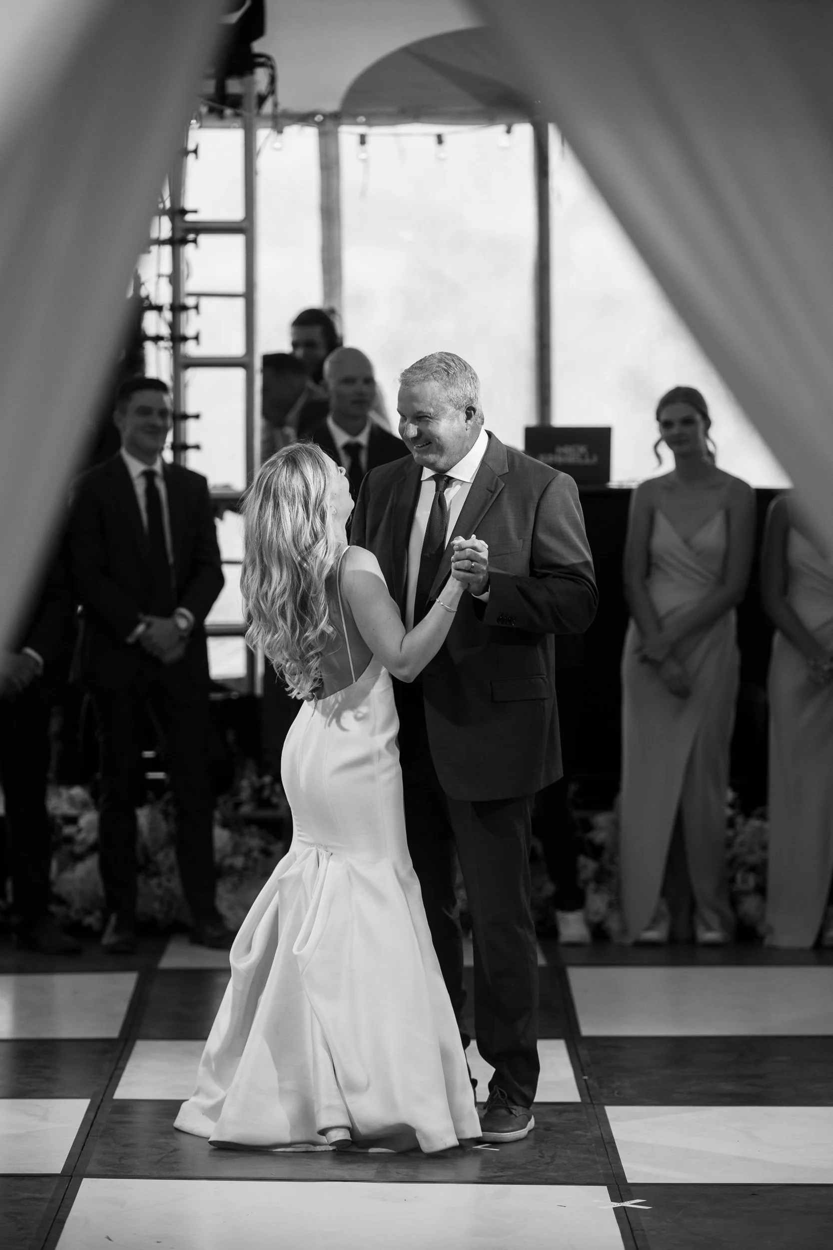 Black-and-white first dance on a checkered floor in a tent in Hot Sulphur Springs, Colorado