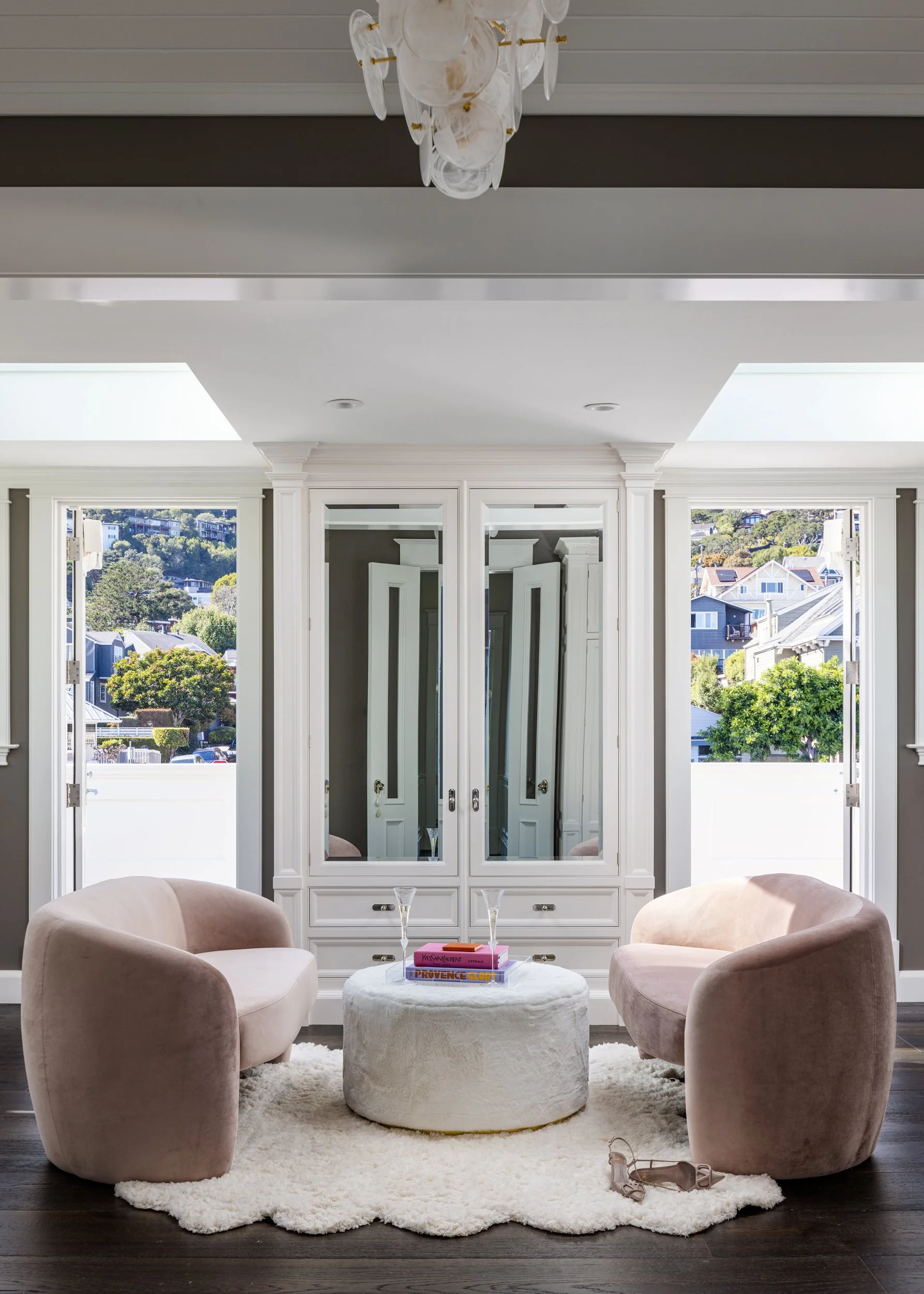 Dressing room with pink swivel chairs, an ottoman and mirrored wardrobe doors, Valhalla, Sausalito
