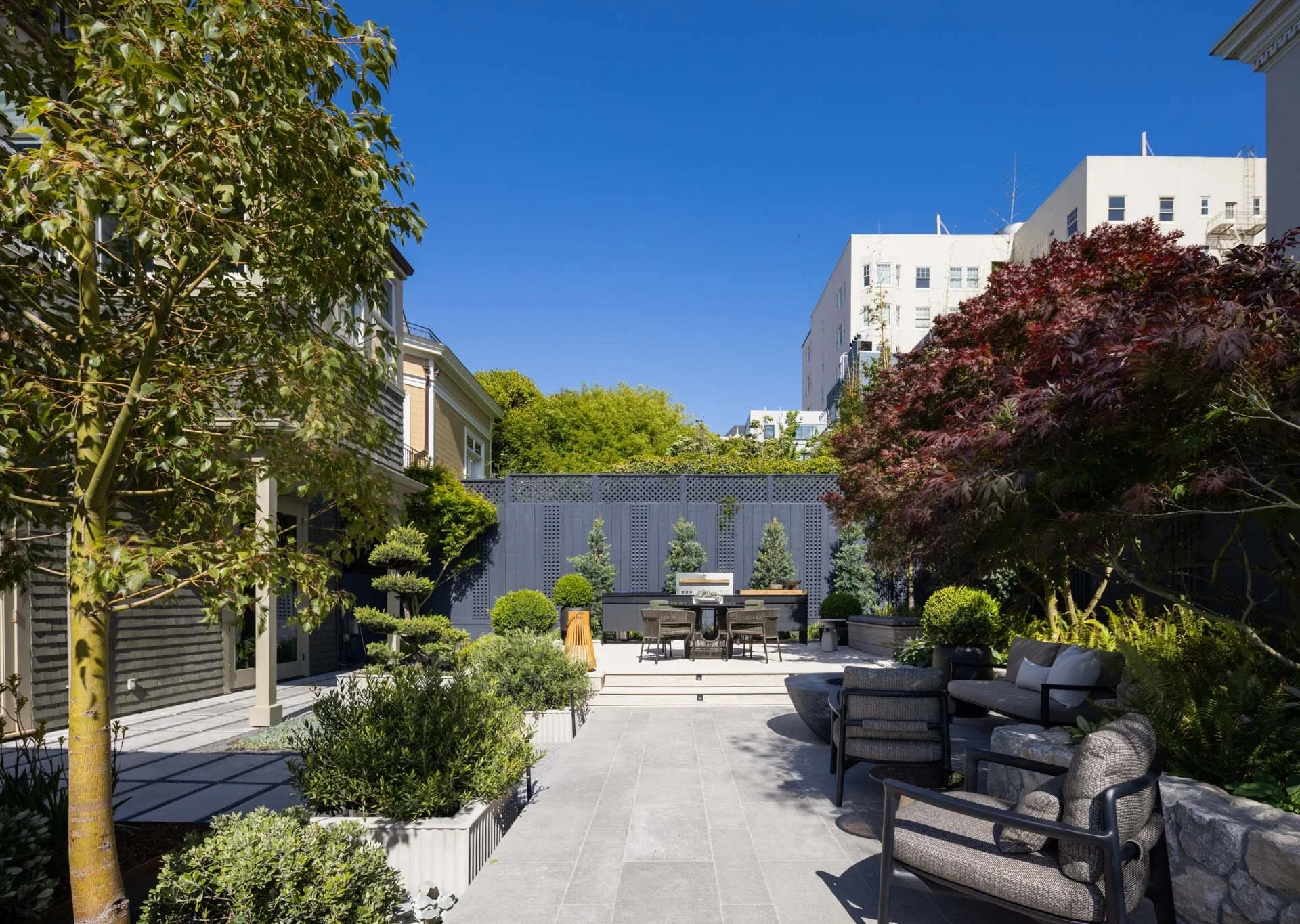 Landscaped rear garden with a stone terrace and outdoor seating, 2315 Broadway, Pacific Heights, San Francisco