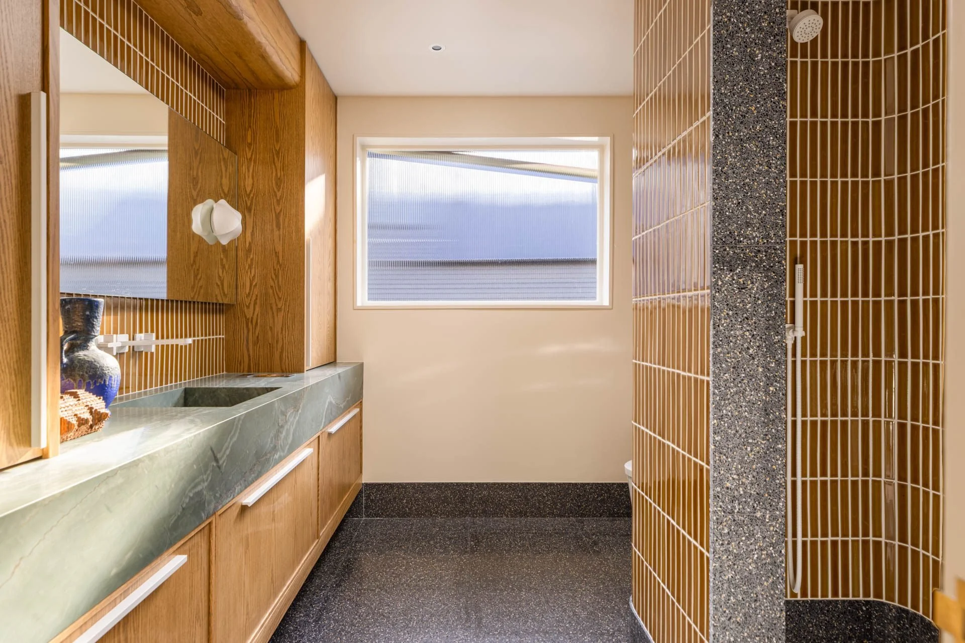 Bathroom with amber glazed tile, a green stone vanity and a window onto the bay, 2315 Broadway, San Francisco Decorator Showcase