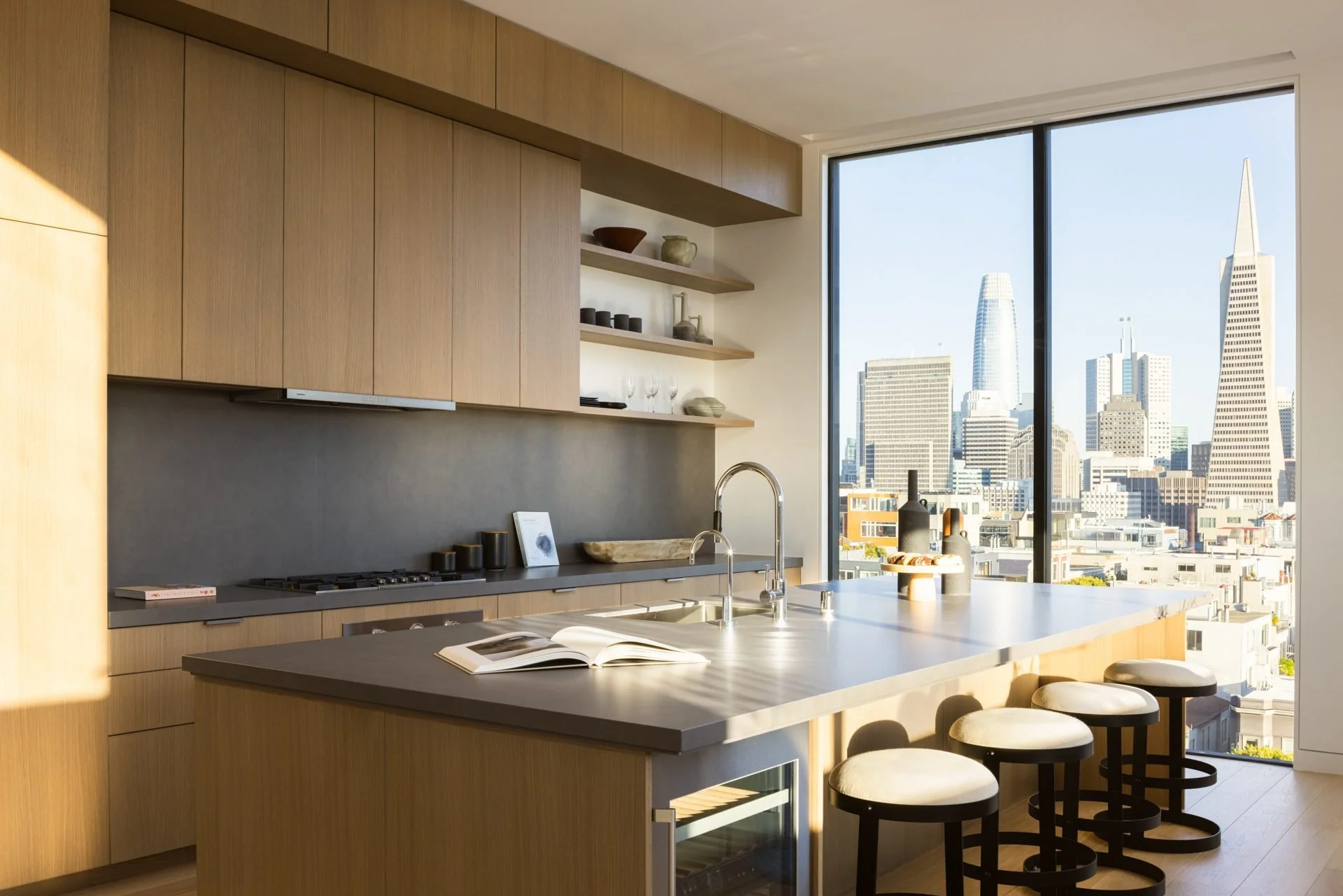 Oak kitchen with a waterfall island and a window view of the Transamerica Pyramid, 119 Telegraph, San Francisco